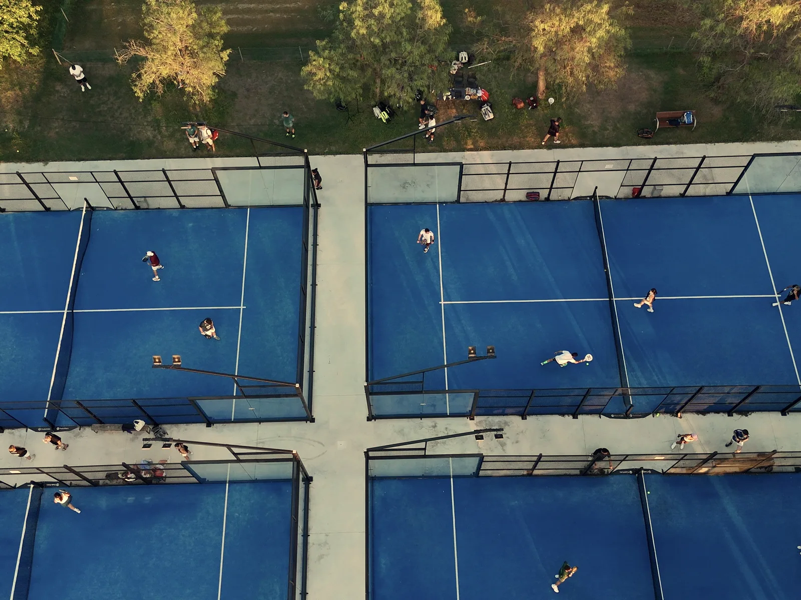 Drone view of the Saladar courts among the trees, with players on court