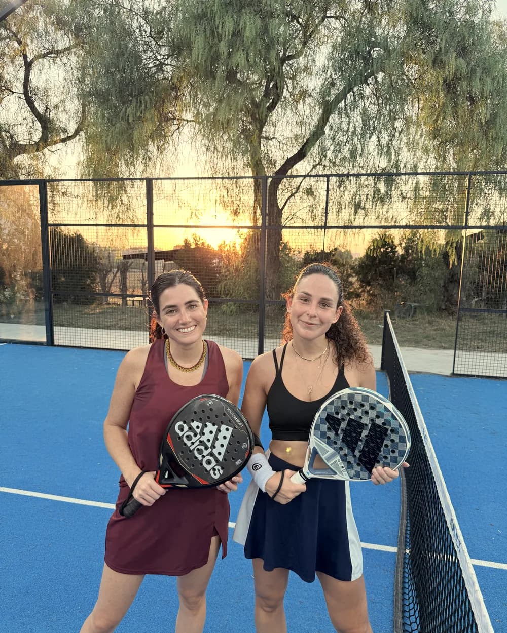Two players with the setting sun behind them